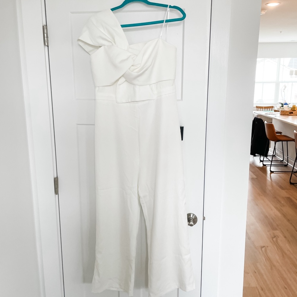 Lulu’s white jumpsuit. One shoulder strap
